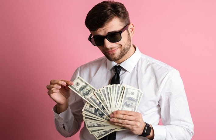 Smart dressed man counting dollar bills
